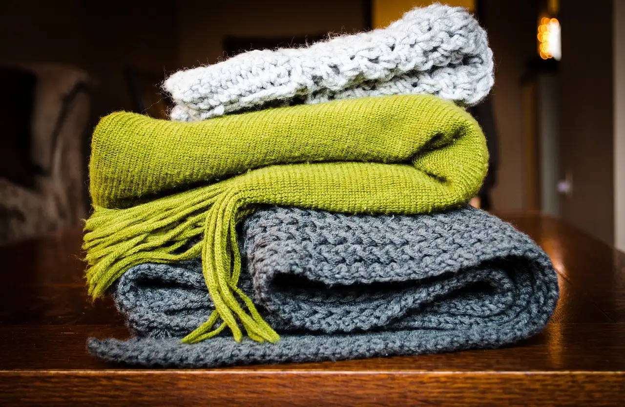 Stack of folded wool knit scarves