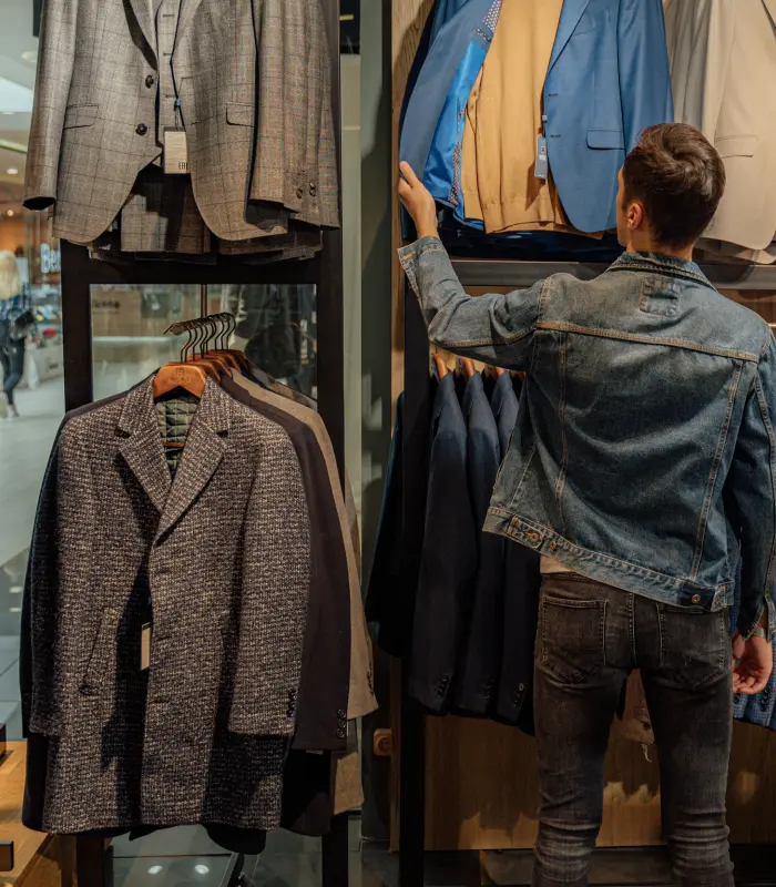 Man checking out tailored coats and blazers